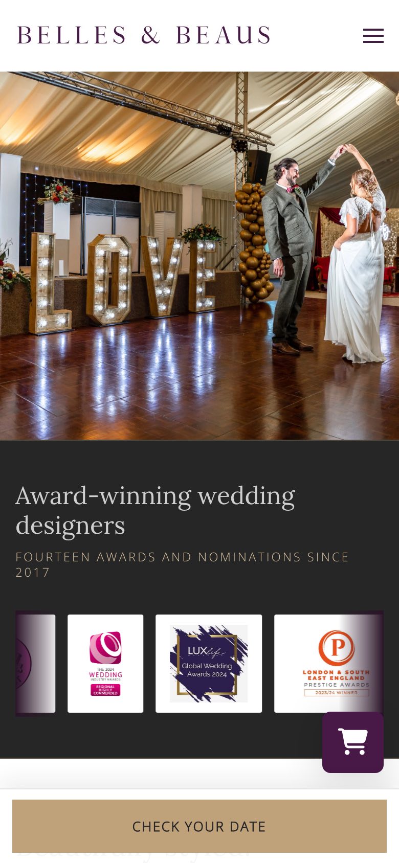 The Belles & Beaus site on a phone: a photo of a couple dancing beside lit LOVE letters, above a section headed Award-winning wedding designers, fourteen awards and nominations since 2017, with award badges and a Check your date button
