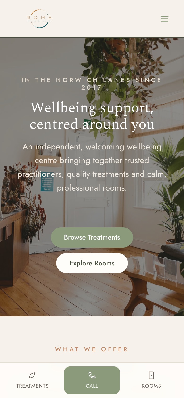 The Soma Wellbeing Centre site on a phone: a warm hero reading Wellbeing support, centred around you, with Browse Treatments and Explore Rooms buttons